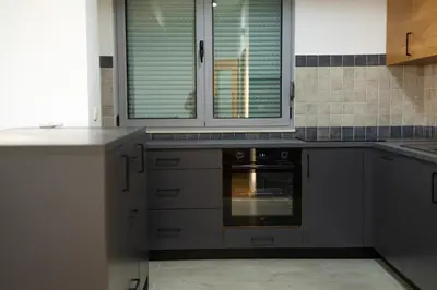 a kitchen with gray cabinets and an oven at Apartment sea view Asija in Bar