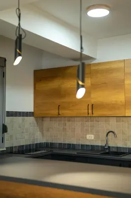 a kitchen with wooden cabinets and a sink at Apartment sea view Asija in Bar