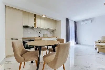 a kitchen and dining room with a table and chairs at Malik Bay RESIDENTS in Bar