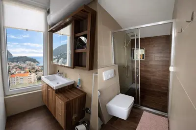 a bathroom with a toilet and a sink and a shower at Blue Vista in Petrovac na Moru