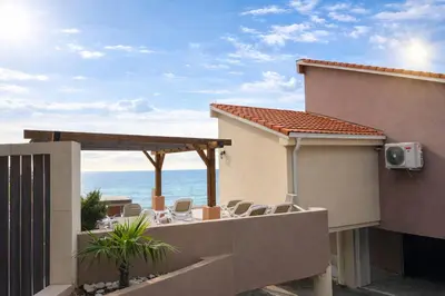 a balcony with chairs and a view of the ocean at Blue Vista in Petrovac na Moru