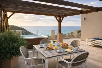 a table with food on a patio with a view of the ocean at Blue Vista in Petrovac na Moru