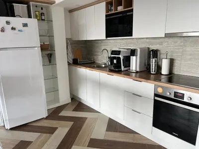 a kitchen with white cabinets and a white refrigerator at Blue Vista in Petrovac na Moru