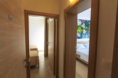 a hallway with a door leading to a bedroom at Riva Lux Apartments in Sutomore