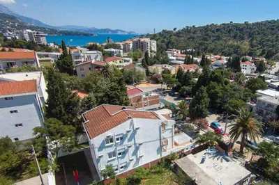an aerial view of a city with a town and water at Riva Lux Apartments in Sutomore