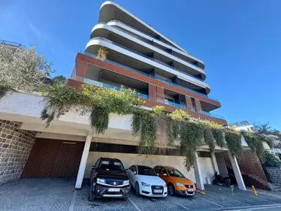 two cars parked in front of a building at Royal Residence Penthouse - Budva, Center in Budva