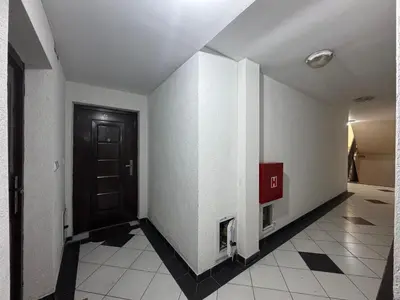 a hallway with a black door and a tile floor at Panoramic Sea View - Two Bedroom Apartment - Budva Center in Budva
