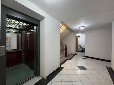 a hallway of a building with a glass door at Panoramic Sea View - Two Bedroom Apartment - Budva Center in Budva