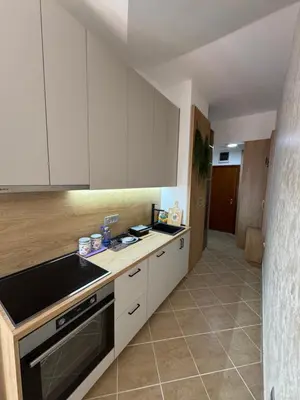 a kitchen with white cabinets and a stove top oven at Apartman Sunce in Budva