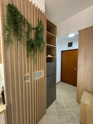 a hallway with a wooden partition with plants on it at Apartman Sunce in Budva