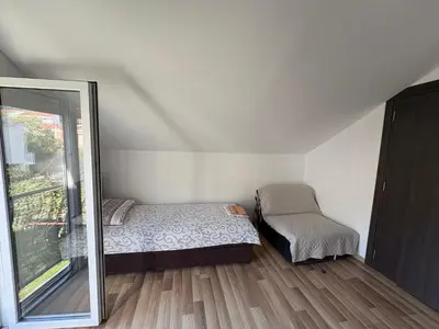 a small bedroom with a bed and a mirror at Solis Apartments Sutomore in Sutomore