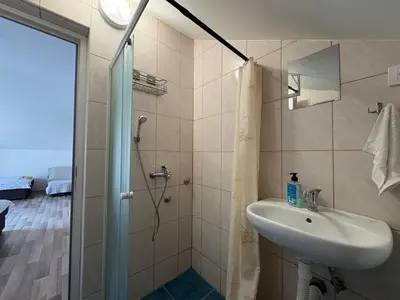 a bathroom with a sink and a shower at Solis Apartments Sutomore in Sutomore
