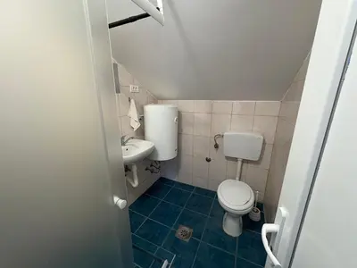 a small bathroom with a toilet and a sink at Solis Apartments Sutomore in Sutomore