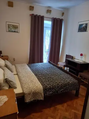 a bedroom with a bed and a window at Apartman Nikoleta in Kotor