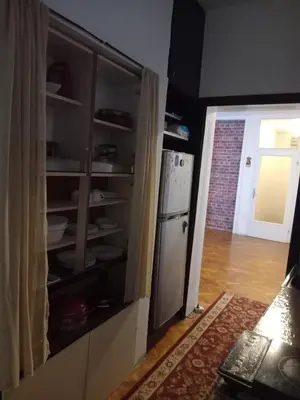 a kitchen with a white refrigerator and a door at Apartman Nikoleta in Kotor