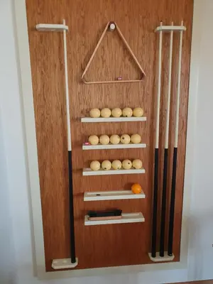 a wooden cabinet with baseball equipment in it at Villa Jelena in Reževići