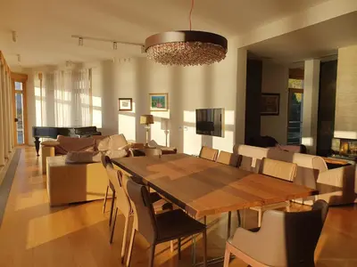 a living room with a table and a couch at Villa Jelena in Reževići
