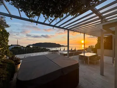 a patio with a table and a view of the ocean at Exclusive Luxury Villa in Dukley Gardens in Budva