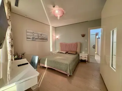 a small bedroom with a bed and a dresser at Exclusive Luxury Villa in Dukley Gardens in Budva