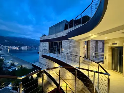 a building with a spiral staircase with a view of the water at Exclusive Luxury Villa in Dukley Gardens in Budva