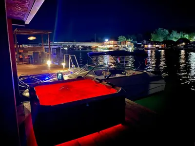 a boat is docked at a dock at night at Amazonas Pirates 3 in Ulcinj