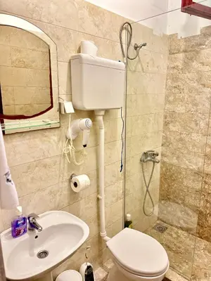 a bathroom with a toilet and a sink and a mirror at Amazonas Pirates 3 in Ulcinj