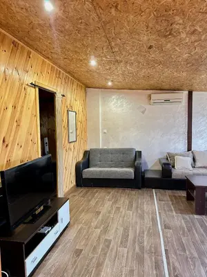 a living room with a couch and a television at Amazonas Pirates 3 in Ulcinj
