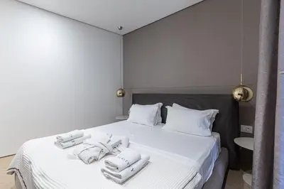 a bedroom with a white bed with towels on it at Luxury Dukley Villa in Boreti