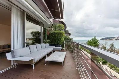 a balcony with white furniture and a view of the ocean at Luxury Dukley Villa in Boreti