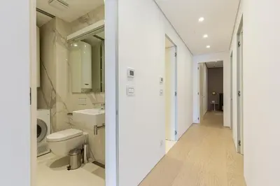 a white bathroom with a toilet and a sink at Luxury Dukley Villa in Boreti