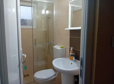 a bathroom with a toilet and a sink and a shower at Beachfront Sunset Apartments Sutomore in Brca