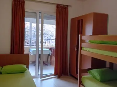 a bedroom with two bunk beds and a balcony at Beachfront Sunset Apartments Sutomore in Brca