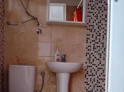 a bathroom with a sink and a toilet and a mirror at Beachfront Sunset Apartments Sutomore in Brca