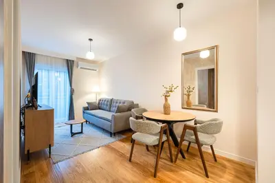 a living room with a table and a couch at Fratello Apartment in Podgorica
