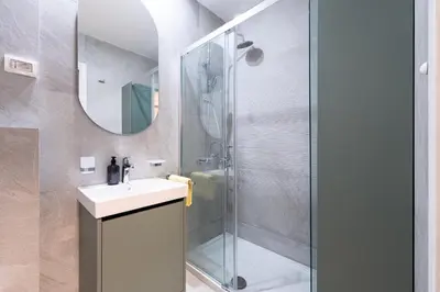 a bathroom with a sink and a shower at Fratello Apartment in Podgorica