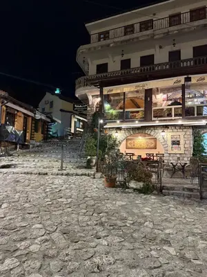 a building at night with a cobblestone street at Villa & Pool in Utjeha