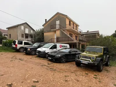 a group of cars parked in front of a house at Villa & Pool in Utjeha