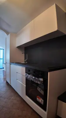 a kitchen with an oven and white cabinets at Central Studio Apartment in Bar
