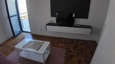 a living room with a tv and a coffee table at Central Studio Apartment in Bar