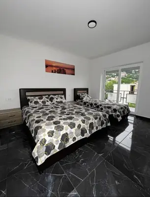 a bedroom with a bed with a comforter on it at rent stan sutomore in Sutomore
