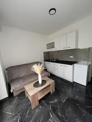 a kitchen with a vase on a table in a room at rent stan sutomore in Sutomore