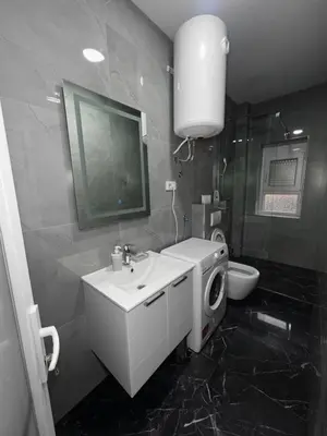 a black and white bathroom with a sink and a toilet at rent stan sutomore in Sutomore