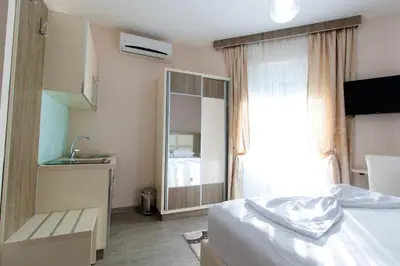 a bedroom with a bed and a sink and a mirror at A3 Apartments in Ulcinj