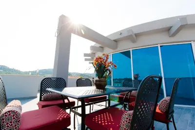 a patio with a table and chairs on a balcony at A3 Apartments in Ulcinj
