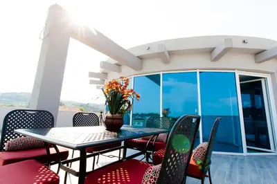 a table and chairs on a balcony with a table and flowers at A3 Apartments in Ulcinj