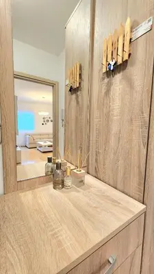 a bathroom with a mirror and a counter with a sink at Central Light Apartment in Podgorica