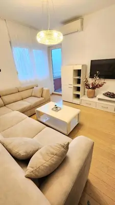 a living room with a couch and a coffee table at Central Light Apartment in Podgorica