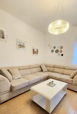 a living room with a couch and a coffee table at Central Light Apartment in Podgorica