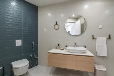 a bathroom with a sink and a toilet and a mirror at Stunning Bečići Apartment in Becici