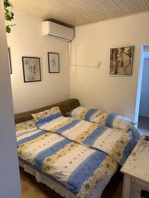 a bedroom with a bed with two pillows on it at Kutak in Podgorica